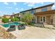 Luxurious backyard with a sparkling pool, lush landscaping, and comfortable lounge chairs for relaxation at 3817 E Patrick Ln, Phoenix, AZ 85050