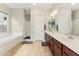 Bright bathroom boasts double vanity, tile floors, soaking tub, and walk-in shower, offering luxury and convenience at 3817 E Patrick Ln, Phoenix, AZ 85050
