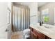 Neutral bathroom featuring a shower/tub combination and a single sink vanity, offering functionality at 3817 E Patrick Ln, Phoenix, AZ 85050