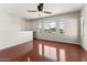 Bright bonus room boasts wood floors, neutral paint, and a ceiling fan, offering a versatile space at 3817 E Patrick Ln, Phoenix, AZ 85050
