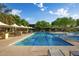 Beautiful community pool with lap lanes, tables with umbrellas, and lush landscaping at 3817 E Patrick Ln, Phoenix, AZ 85050