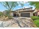 Attractive home featuring desert landscaping, a tile roof, and a spacious three-car garage at 3817 E Patrick Ln, Phoenix, AZ 85050