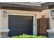 Close up of a two car garage with a private gate and updated lighting at 3817 E Patrick Ln, Phoenix, AZ 85050