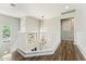 Bright hallway with wood flooring, a white railing, and a modern light fixture at 3817 E Patrick Ln, Phoenix, AZ 85050