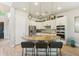This gourmet kitchen features a granite island with seating and stainless steel appliances and white cabinetry at 3817 E Patrick Ln, Phoenix, AZ 85050