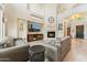 Comfortable living room with a fireplace, high ceilings, and an open staircase at 3817 E Patrick Ln, Phoenix, AZ 85050