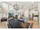Open floorplan showcasing kitchen, dining area, and a cozy living room with fireplace and large-screen TV at 3817 E Patrick Ln, Phoenix, AZ 85050