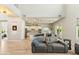Bright, open-concept living room with a modern kitchen, stylish gray sofa, and wood-look tile flooring at 3817 E Patrick Ln, Phoenix, AZ 85050