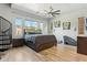 Spacious main bedroom with wood-look floors, a spiral staircase, and natural light from multiple windows at 3817 E Patrick Ln, Phoenix, AZ 85050