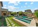 Inviting backyard featuring a sparkling pool, spa, and outdoor kitchen area perfect for entertaining at 3817 E Patrick Ln, Phoenix, AZ 85050