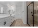 Modern bathroom with double vanity, matte black hardware and walk-in shower at 40595 W Michaels Dr, Maricopa, AZ 85138