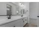 Bathroom featuring double sinks, mirrors, and modern black fixtures at 40595 W Michaels Dr, Maricopa, AZ 85138