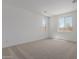 Bright bedroom featuring neutral carpet, two windows and white walls at 40595 W Michaels Dr, Maricopa, AZ 85138