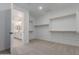 Walk-in closet that leads to an ensuite bathroom featuring built-in shelving at 40595 W Michaels Dr, Maricopa, AZ 85138