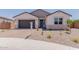 Charming single-story home with a two-car garage, desert landscaping, and a welcoming front porch at 40595 W Michaels Dr, Maricopa, AZ 85138