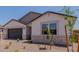 Charming single-story home with desert landscaping, stone accents, and a two-car garage at 40595 W Michaels Dr, Maricopa, AZ 85138