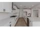 Stylish kitchen featuring white cabinets, quartz countertops, stainless steel appliances, and modern hardware at 40595 W Michaels Dr, Maricopa, AZ 85138