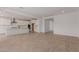 Open concept living room flowing into kitchen featuring tile floors and great natural lighting at 40595 W Michaels Dr, Maricopa, AZ 85138