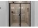Modern shower with black trim, built-in niche, and rainfall shower head at 40595 W Michaels Dr, Maricopa, AZ 85138