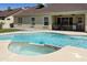 Rear exterior view showcasing the pool, covered patio, and well-maintained backyard at 4137 W Cielo Grande --, Glendale, AZ 85310