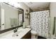Bright bathroom features a single vanity, framed mirror, and polka dot shower curtain at 4137 W Cielo Grande --, Glendale, AZ 85310
