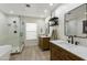 Bright bathroom featuring dual sinks, stand alone tub, glass enclosed shower, and modern fixtures at 4137 W Cielo Grande --, Glendale, AZ 85310