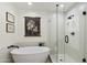 Modern bathroom featuring a soaking tub, walk-in shower, and hexagon tile at 4137 W Cielo Grande --, Glendale, AZ 85310