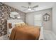 Stylish bedroom with a floral accent wall, ornate mirror, and comfortable upholstered bed at 4137 W Cielo Grande --, Glendale, AZ 85310