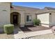 Inviting home exterior with arched entryway, neutral stucco, and low maintenance landscaping at 4137 W Cielo Grande --, Glendale, AZ 85310