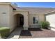 Charming home exterior with arched entryway, neutral stucco, and easy care landscaping at 4137 W Cielo Grande --, Glendale, AZ 85310
