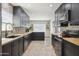 Spacious kitchen with dark cabinets, butcher block counters, stainless steel appliances, and lots of natural light at 4137 W Cielo Grande --, Glendale, AZ 85310