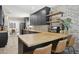 Charming kitchen features butcher block counters, brick accents, stainless appliances, and custom cabinets at 4137 W Cielo Grande --, Glendale, AZ 85310