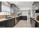Modern kitchen featuring stainless steel appliances, butcher block counters, dark cabinetry, and stylish backsplash at 4137 W Cielo Grande --, Glendale, AZ 85310