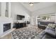 Bright living room featuring a fireplace, vaulted ceiling, and sliding doors to outdoor living at 4137 W Cielo Grande --, Glendale, AZ 85310