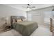 Inviting main bedroom with a plush green comforter, bedside table, and ceiling fan at 4137 W Cielo Grande --, Glendale, AZ 85310