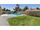 Inviting backyard features a sparkling pool, lush grass, and mature trees for a relaxing outdoor experience at 4137 W Cielo Grande --, Glendale, AZ 85310
