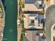 Aerial view showcases home's roof, driveway, waterfront, turf yard and neighboring properties at 41584 W Springtime Rd, Maricopa, AZ 85138