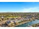 Expansive aerial view of a well-planned community with homes surrounding a tranquil lake at 41584 W Springtime Rd, Maricopa, AZ 85138
