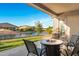 Inviting covered back patio features a fire pit, comfortable seating and scenic waterfront views at 41584 W Springtime Rd, Maricopa, AZ 85138