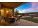 Relaxing back patio with a fire pit, waterfront view, and comfortable seating arrangement at 41584 W Springtime Rd, Maricopa, AZ 85138