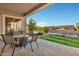 Inviting covered back patio features a fire pit, comfortable seating and scenic waterfront views at 41584 W Springtime Rd, Maricopa, AZ 85138