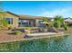 Beautiful backyard featuring a patio, a small patch of grass, and waterfront access at 41584 W Springtime Rd, Maricopa, AZ 85138