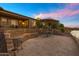 Backyard retreat offers waterfront living with a spacious patio and beautifully landscaped areas at 41584 W Springtime Rd, Maricopa, AZ 85138