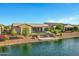 The backyard offers a tranquil retreat with lush landscaping and direct water access at 41584 W Springtime Rd, Maricopa, AZ 85138