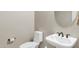 Half bath featuring a pedestal sink and efficient toilet at 41584 W Springtime Rd, Maricopa, AZ 85138