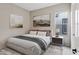 Neutral bedroom with a cozy king-size bed and stylish nightstand at 41584 W Springtime Rd, Maricopa, AZ 85138