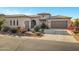 Charming, Southwestern-style home with a well-manicured lawn and a three-car garage at 41584 W Springtime Rd, Maricopa, AZ 85138