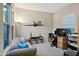 Bright home office with a comfortable couch and functional workstation at 41584 W Springtime Rd, Maricopa, AZ 85138