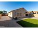Well-maintained backyard with synthetic grass and a covered parking area at 42067 W Anne Ln, Maricopa, AZ 85138