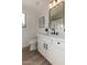 Stylish bathroom with modern fixtures, white vanity, and black accents exudes contemporary elegance at 42067 W Anne Ln, Maricopa, AZ 85138